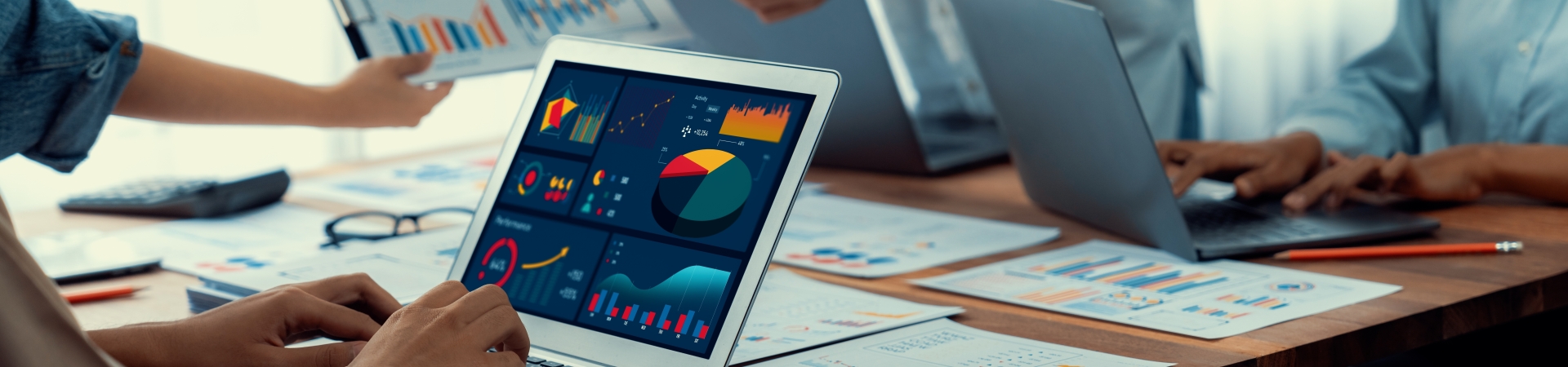 Person working at Laptop showing Data Charts